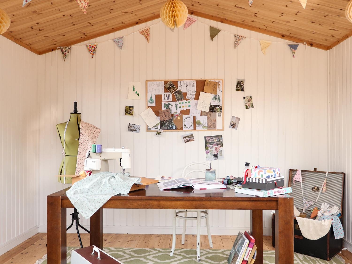 Sewing setup inside a Garden Room, with mannequin, sewing machine and materials